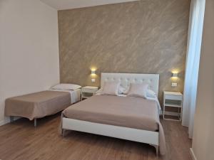 a bedroom with two beds and two night stands at City Center Suite in Termoli