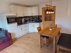 a kitchen and dining room with a wooden table at Pilzhof in Schleching