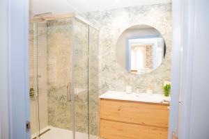 a bathroom with a shower and a sink and a mirror at Casa da Marisma in Redondela