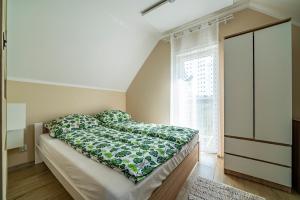 Postel nebo postele na pokoji v ubytování Szmaragdowe Morze