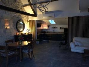 a living room with a table and a couch at Loft à Tours Nord in Tours +8 photos