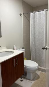 a bathroom with a toilet and a sink and a shower at CONDOMINIO PANORAMIC in Lima