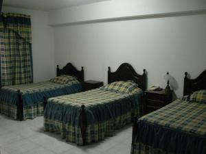 una habitación de hotel con 2 camas en una habitación en Hotel JSF, en Horta