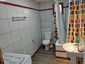 a bathroom with a toilet and a sink at Cabañas y hostal Aurora in Castro