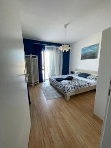 a bedroom with a bed and a door open at Apartmani Fulir in Vrsi
