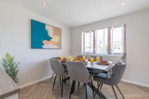 a dining room with a table and chairs at Stunning Five Bed Detached Home in Golden Valley