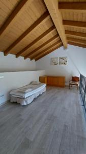 a large room with a bed and a wooden ceiling at Santa Croce in Fanano