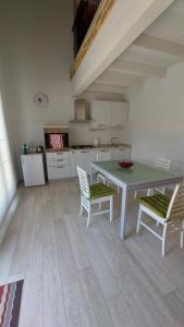a kitchen with a table and chairs in a room at Santa Croce in Fanano