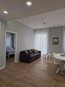 a living room with a couch and a table at City Center Apartment in Termoli