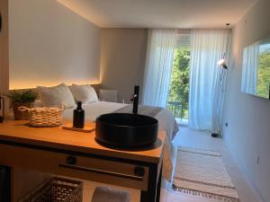 a bedroom with a bed with a bowl on a table at Hotel Farsund in Sanxenxo