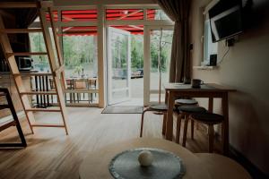 a living room with a table and chairs and a sliding glass door at Wolf Cottage 