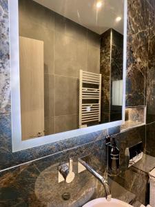 a bathroom with a sink and a large mirror at JV Athens in Athens +22 photos