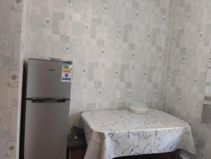 a small room with a table and a refrigerator at Karakol apartment in Karakol