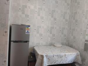 a small room with a table and a refrigerator at Karakol apartment in Karakol +9 photos