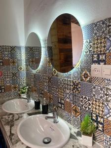 a bathroom with two sinks and a mirror at Rayane Guest House in Taghazout