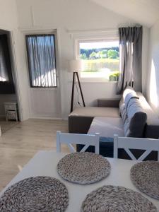 a living room with a couch and a table at BIAŁE DOMKI in Rusinowo +42 photos