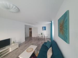 a living room with a blue couch and a table at CAZARE EDI in Corbu