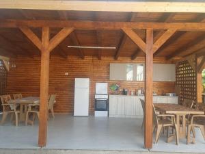 a kitchen with wooden ceilings and a table and chairs at CAZARE EDI in Corbu