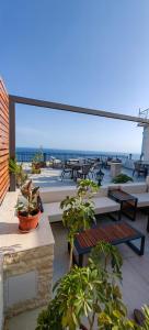 a patio with tables and chairs and a view of the ocean at Adriatic Apartments in Ulcinj