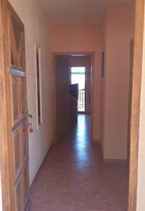 an empty hallway with a door and a television at Apartmani Kerum in Jelsa