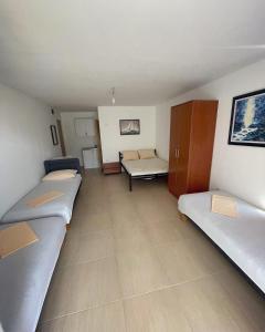 a room with three beds and a couch at Villa Djekovic in Čanj