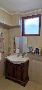 a bathroom with a sink and a mirror at Студио Тони 2 с панорамна тераса и морска гледка Варна in Varna City +47 photos