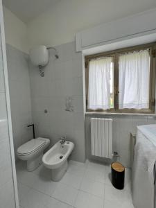 a white bathroom with a toilet and a sink at B&B Il Borgo in Matrice +34 photos