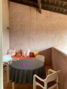 a room with a table and chairs and a couch at Appartement Marina di santa giulia in Porto-Vecchio