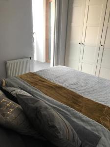 a bedroom with a bed with a wooden blanket at Comfort18 in Bydgoszcz