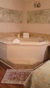 a bath tub in a room with a rug at Boardwalk Plaza Hotel in Rehoboth Beach