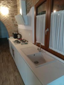 a kitchen with a sink and a counter top at Podere Feltrino in Grosseto