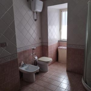 a bathroom with a toilet and a sink at La Piazzetta Alloggio Turistico in Canino +20 photos