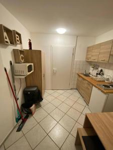 a kitchen with a tiled floor with a mop at Zentrales Apartment: Kreuzberg, Berlin in Berlin