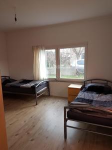 two beds in a room with a window at ByTy 3 in Gransee
