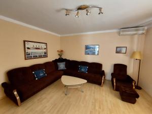 a living room with a brown couch and a table at House Marko in Selce