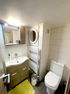 a small bathroom with a toilet and a sink at 20' from the airport,20' from the center of Athens in Athens