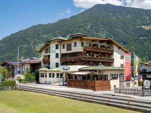 a large building in front of a mountain at Hotel Alpina in Ried im Zillertal