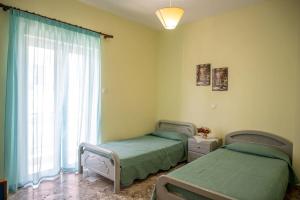 Postel nebo postele na pokoji v ubytování Mythos House
