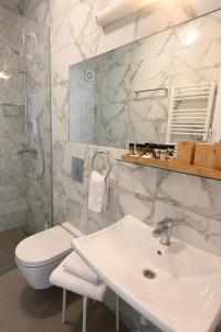 a white bathroom with a sink and a toilet at Apartment Mina Dream in Jelsa +24 photos