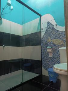 a bathroom with a glass shower with a toilet at Pousada Encontro de Rios in Lençóis +36 photos
