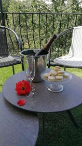 a table with a wine glass and cookies on it at Appartement calme et climatisé au cœur du village in Brazey-en-Plaine