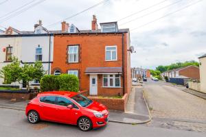 a red car parked in front of a house at 4 bed property, Bolton , Manchester in Egerton