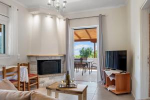 uma sala de estar com lareira e televisão em Ameli Apartment , Spacious With Mountain View, Lefkada em Dhráganon