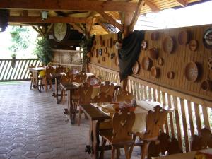a restaurant with wooden tables and people sitting at tables at Penzión Rekrea in Levice