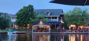 a building with a restaurant on the side of a river at Private 5 BR Muskoka Cottage Firepit+BBQ+Wi-Fi in Bracebridge