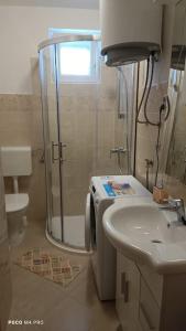 a bathroom with a shower and a sink at Apartment with 2 terrace in Cres