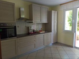 a kitchen with white cabinets and a window at Apartment with 2 terrace in Cres