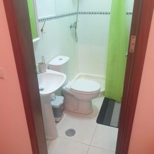 a bathroom with a toilet and a sink at Secularis Capital 2 in Praia +20 photos