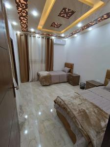 a bedroom with two beds and a ceiling at Petra downtown house in Wadi Musa