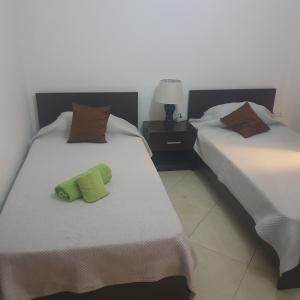 two beds sitting next to each other in a room at Secularis Capital 2 in Praia